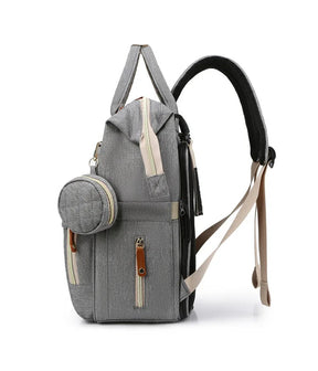 Mochila maternidade 3 em 1 que vira berço portátil prática e funcional.